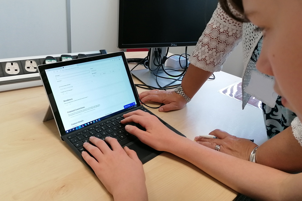 Young person using laptop to apply