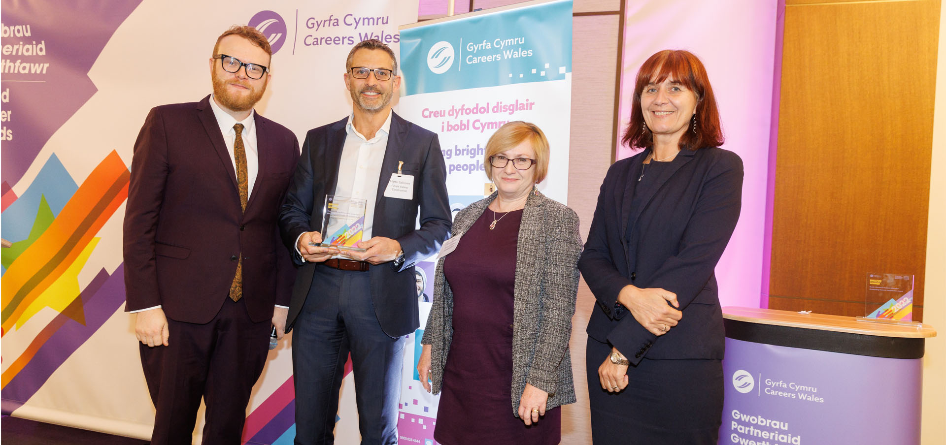Martin Gallimore and Lesley Smith from Future Valleys Construction being presented with their award by presenter Huw Stephens and Nikki Lawrence, Chief Executive, Careers Wales