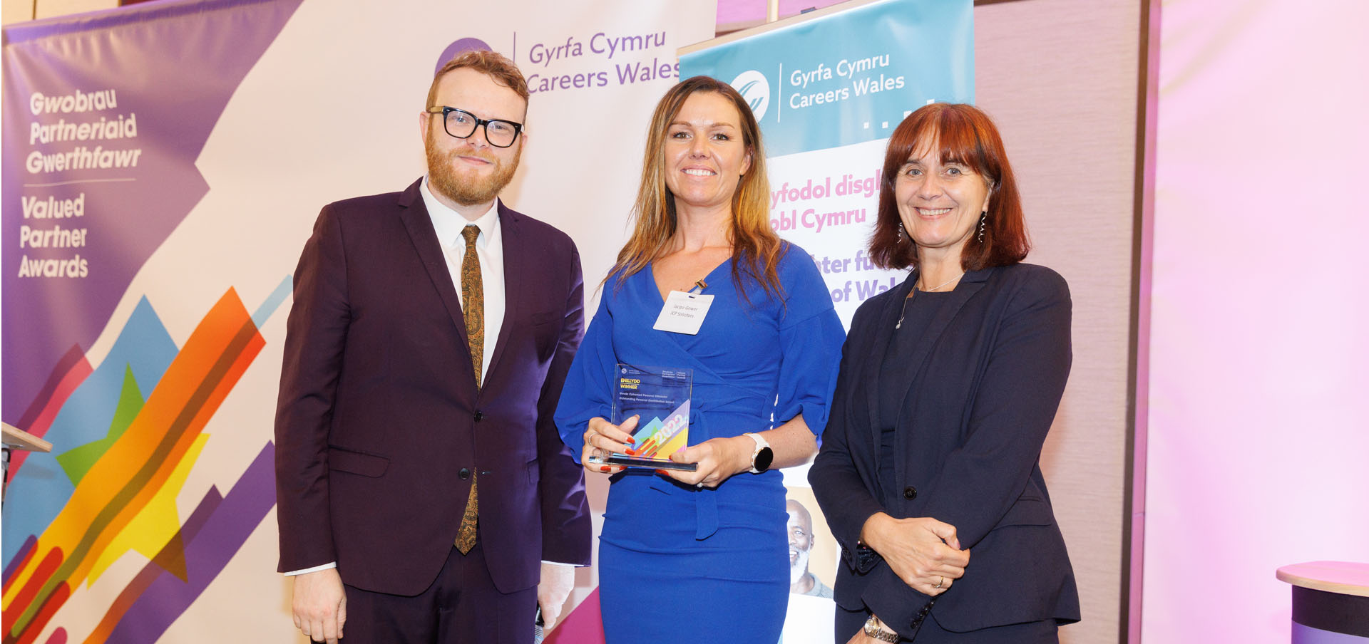 Jacqui Gower from JCP Solicitors being presented with their award by presenter Huw Stephens and Nikki Lawrence, Chief Executive, Careers Wales