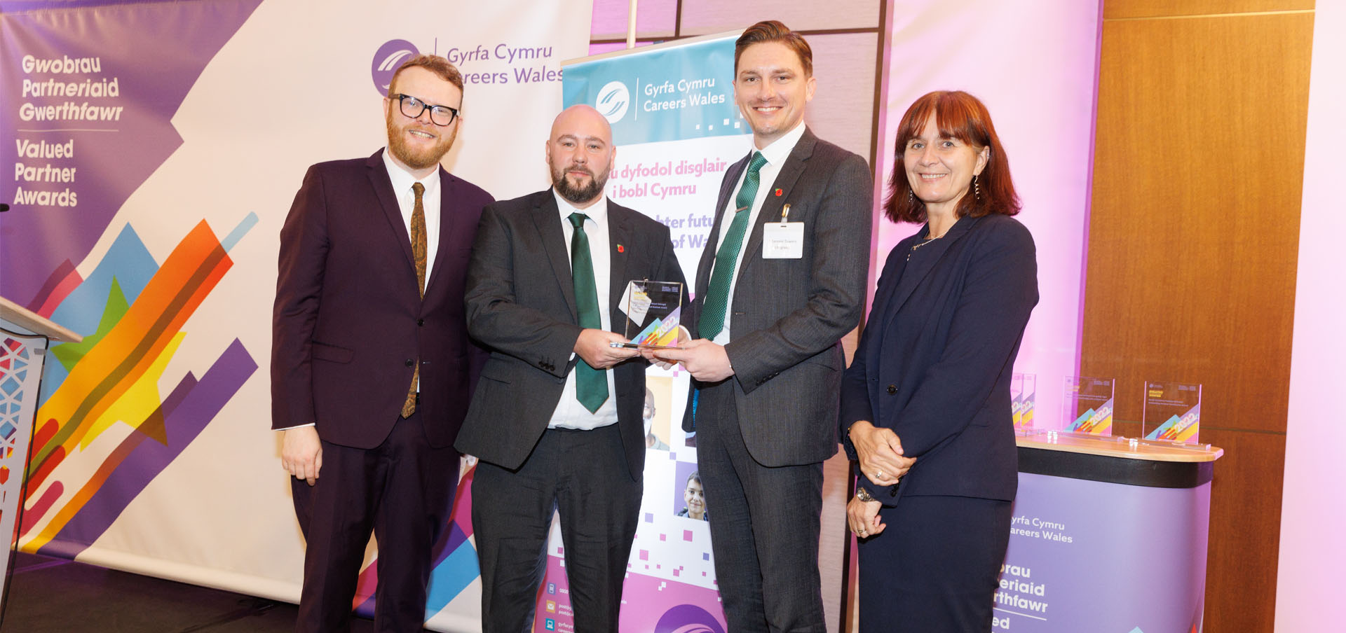David Walker and Shanone Towers from Litegreen being presented with their award by presenter Huw Stephens and Nikki Lawrence, Chief Executive, Careers Wales