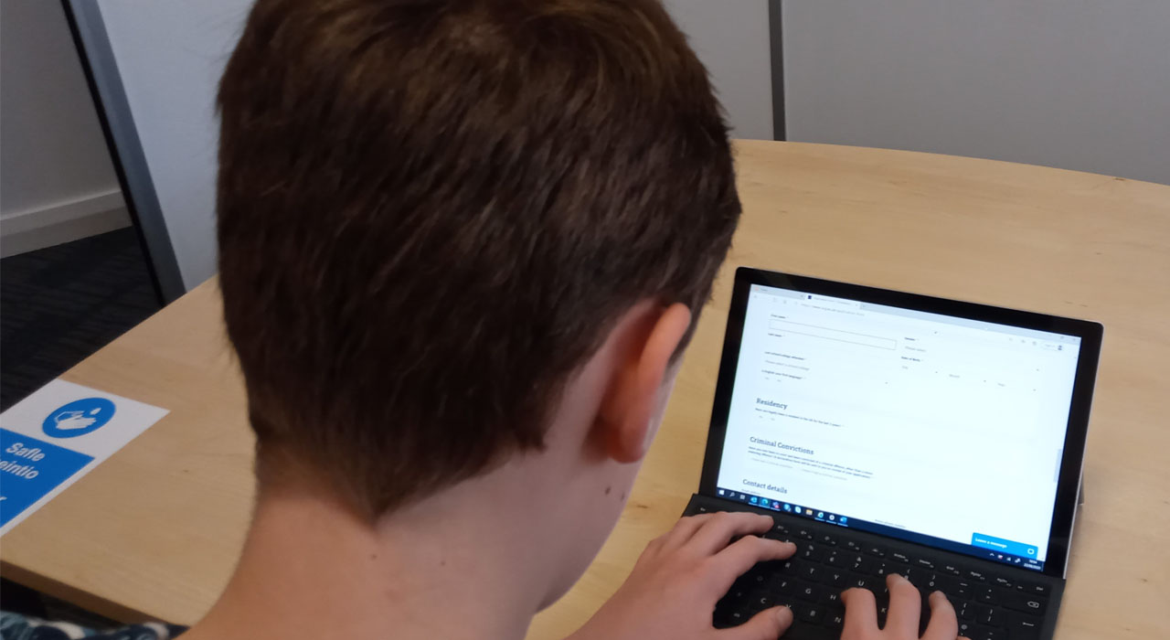 Young person looking at websites on laptop