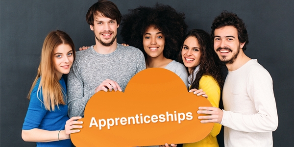 five people holding a sign which says Apprenticeships