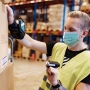 Person scanning boxes in warehouse