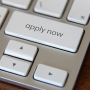 Laptop keyboard with 'apply now' button