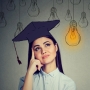 Graduate thinking (a lightbulb emoji is above her)