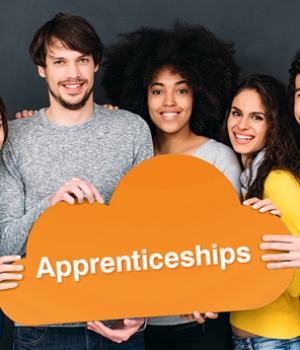 five people holding a sign which says Apprenticeships